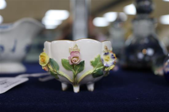 A Meissen flower encrusted cup and saucer